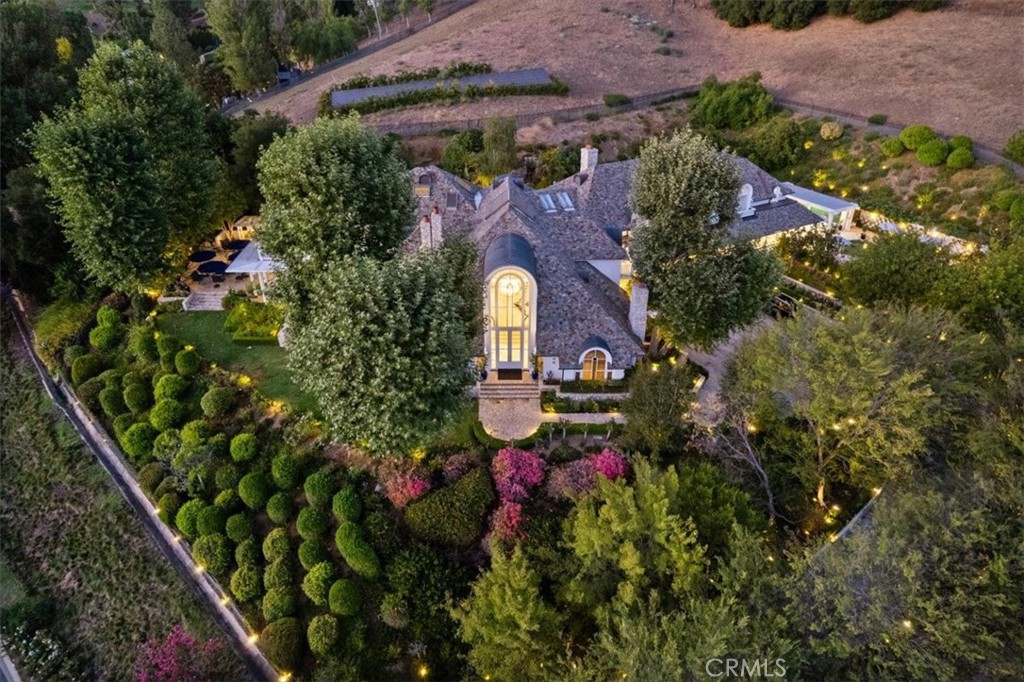 an aerial view of a house with a yard