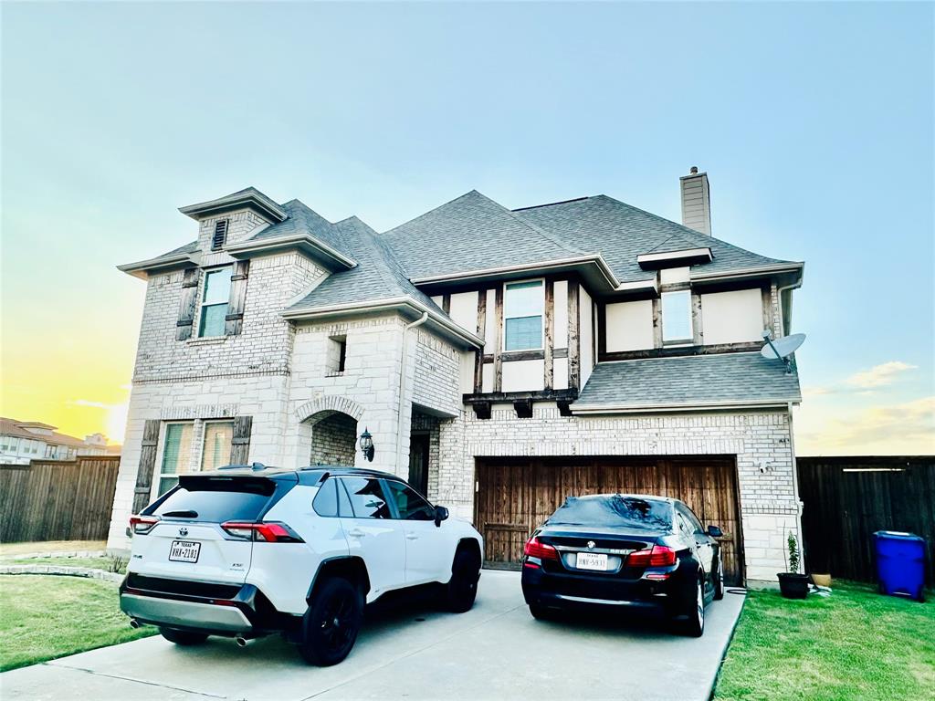 a white car parked in front of a house