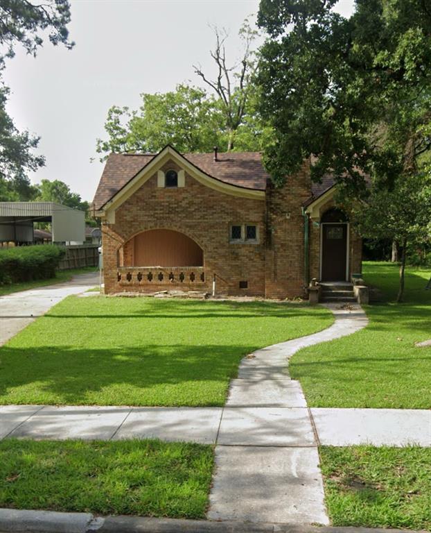 a front view of a house with a garden and yard