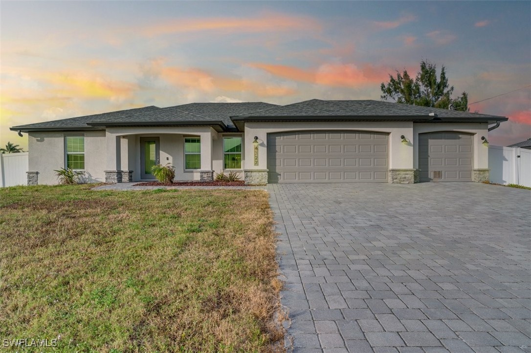 a front view of a house with a yard and garage