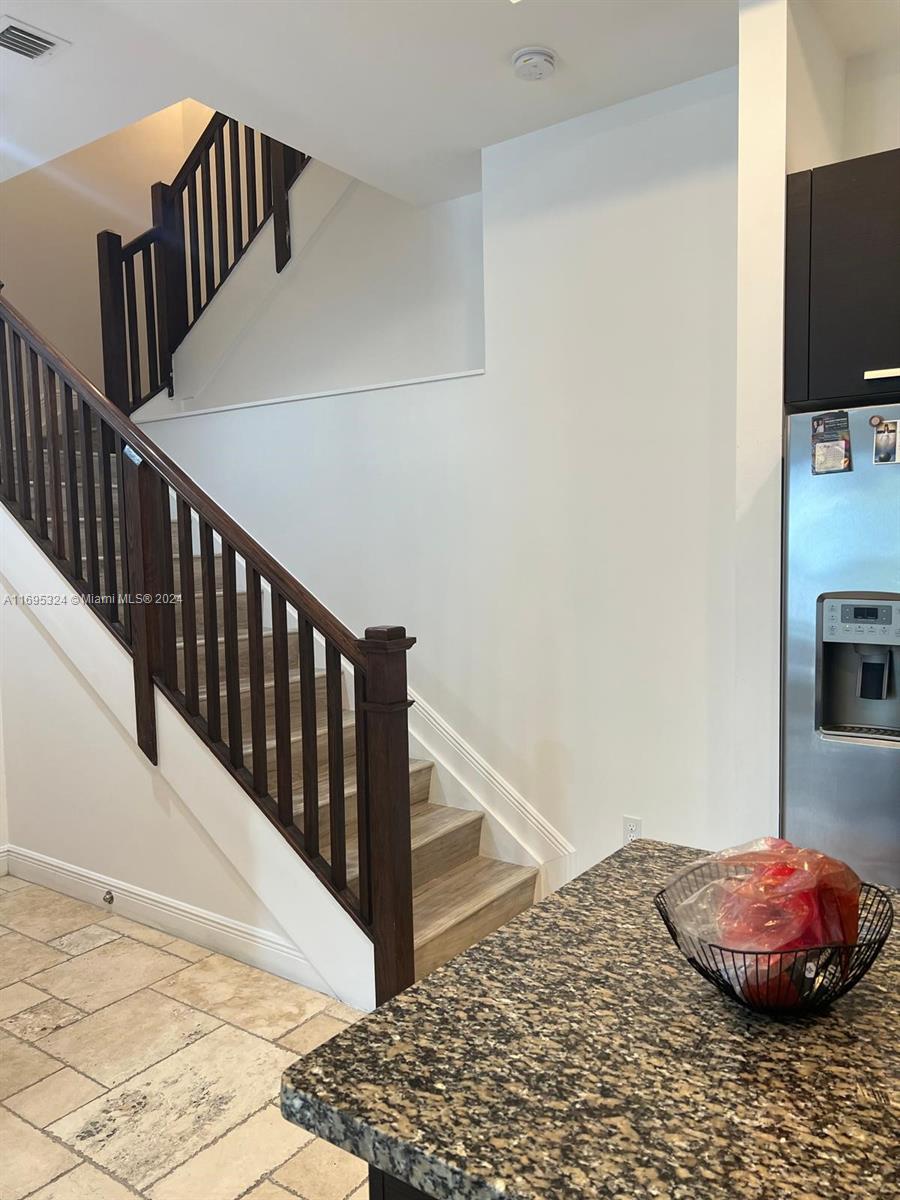 a view of a hallway to a bedroom with stairs