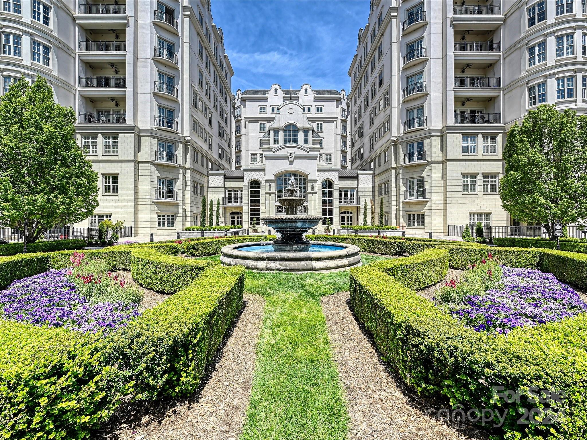 a view of a fountain in front of buildings