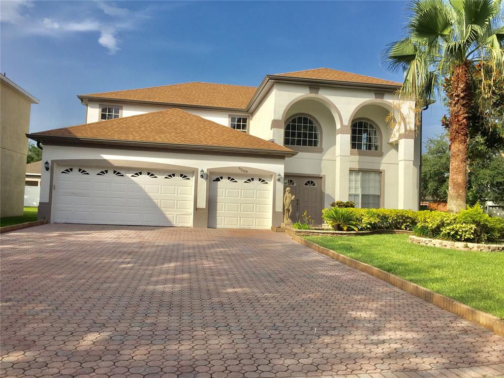 a front view of a house with a yard and garage