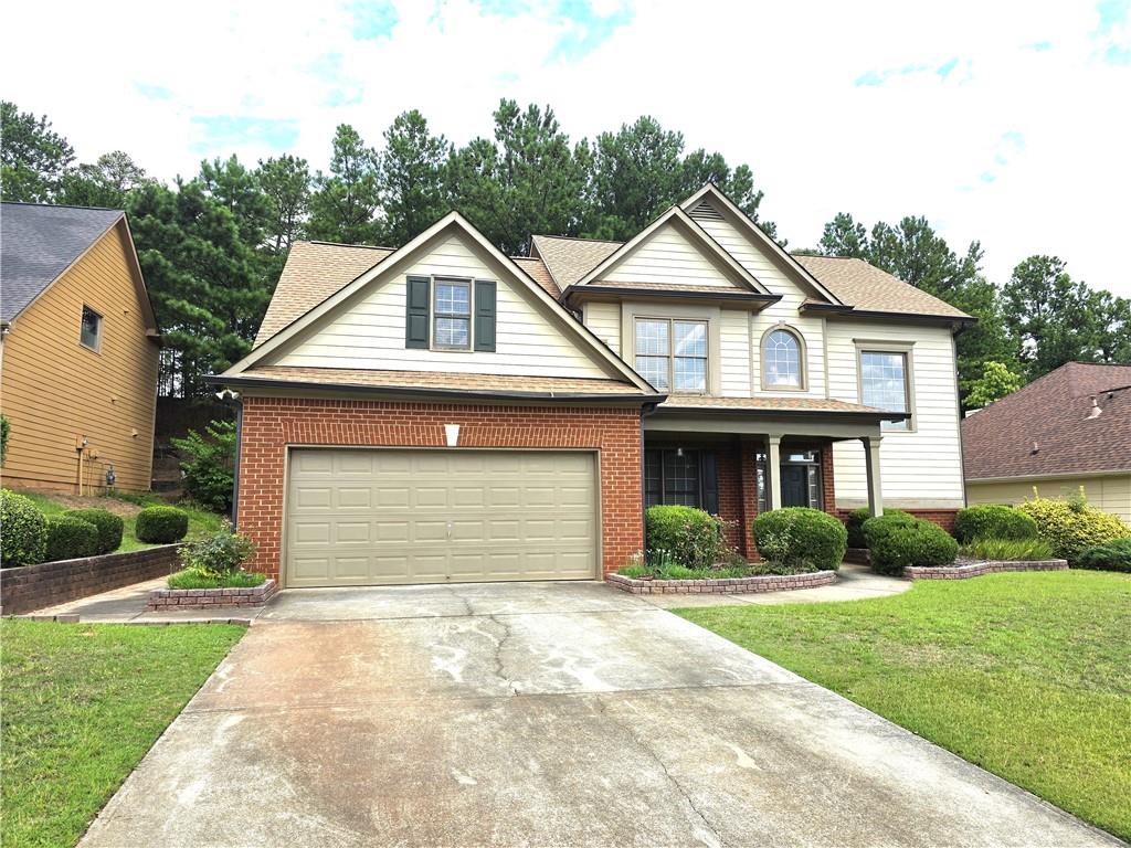 a front view of a house with a yard and garage