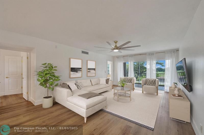 a living room with furniture a large window and a flat screen tv