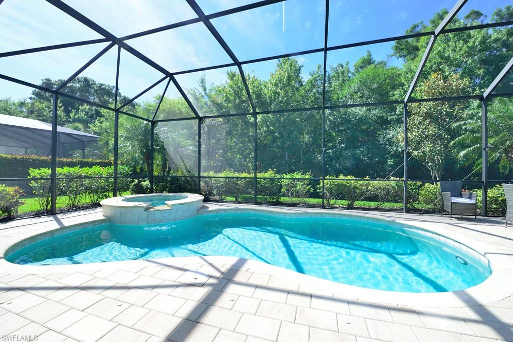 a view of a backyard with plants and patio