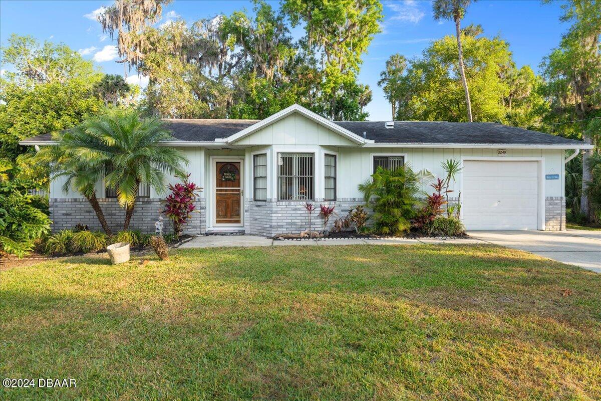 a front view of house with yard and green space