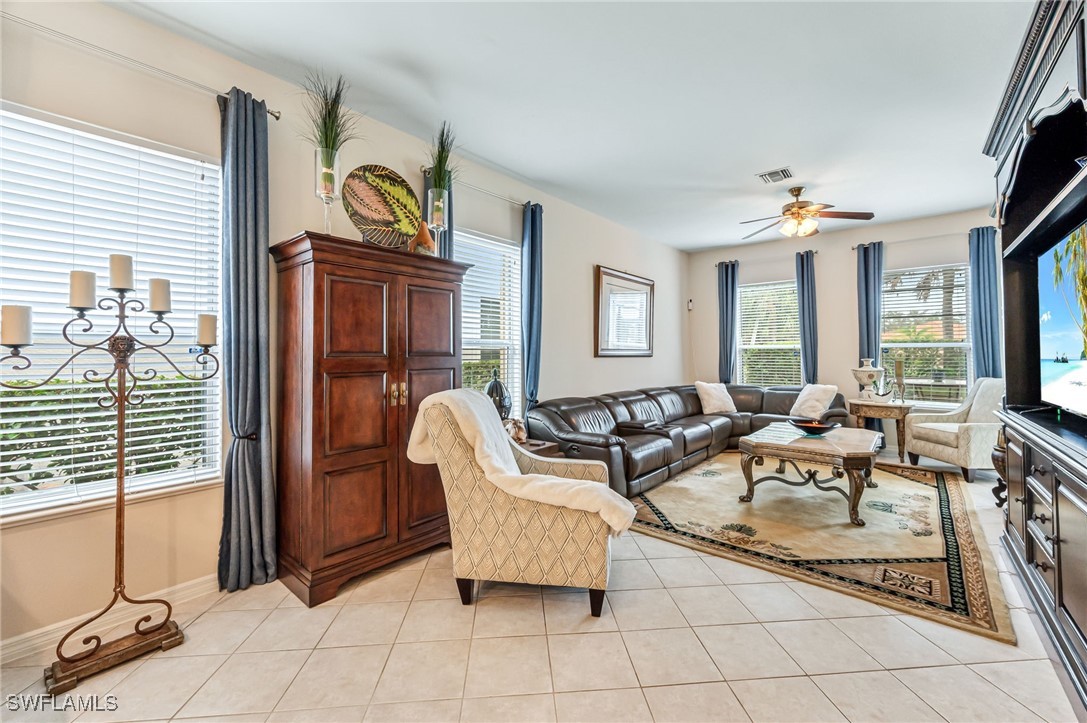 a living room with patio furniture and a flat screen tv