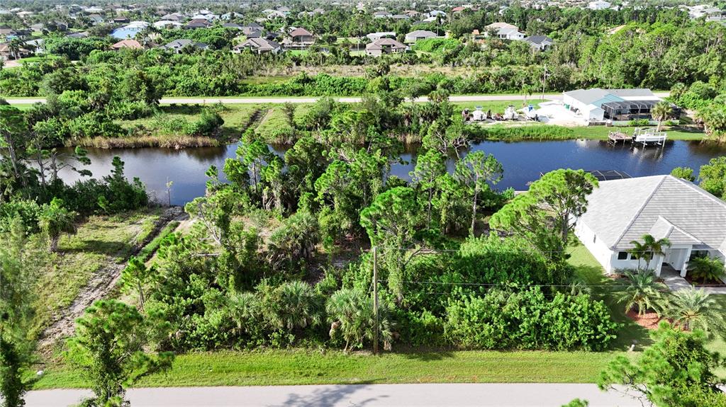 an aerial view of residential houses with outdoor space and trees