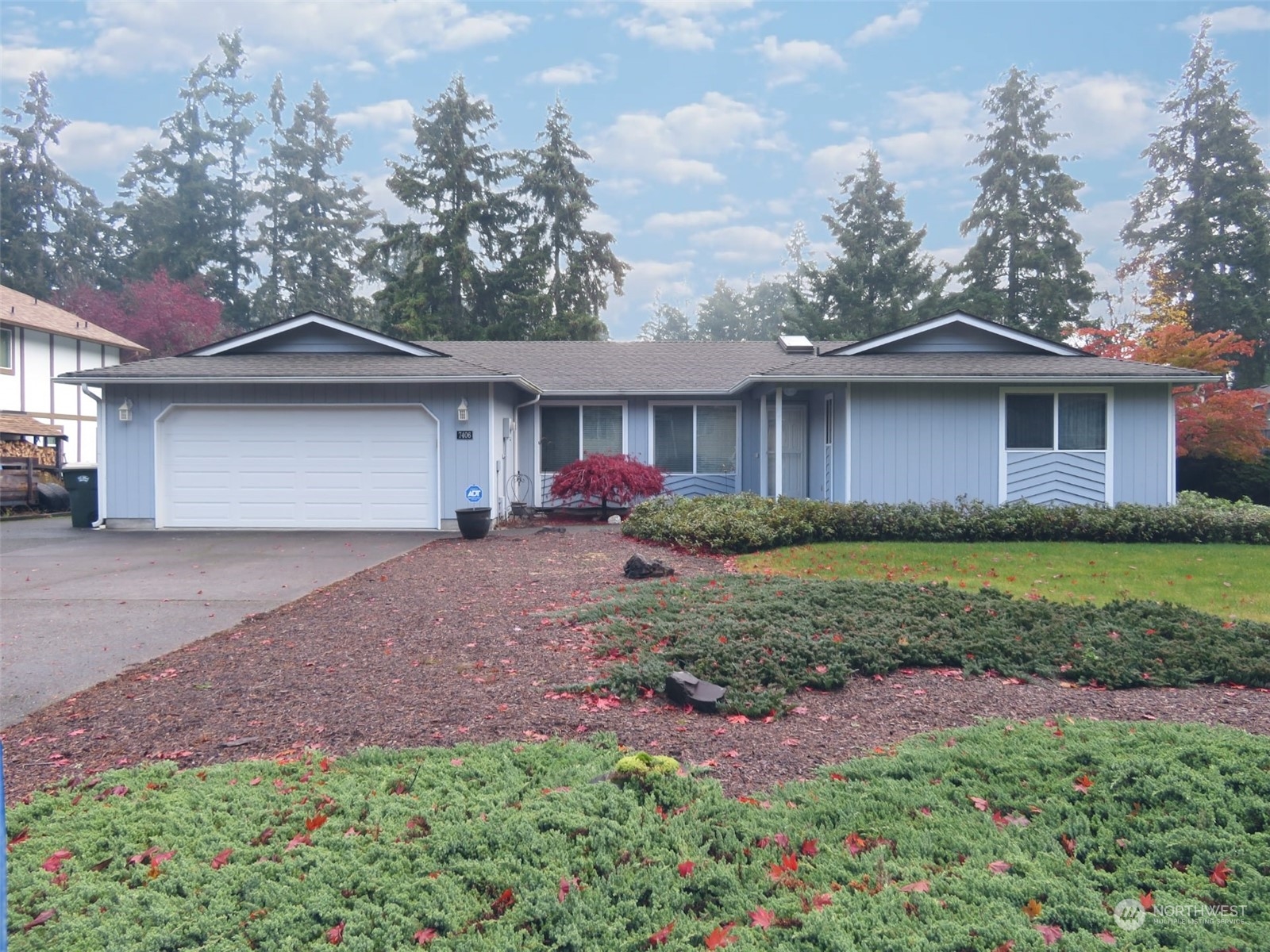 a front view of a house with garden