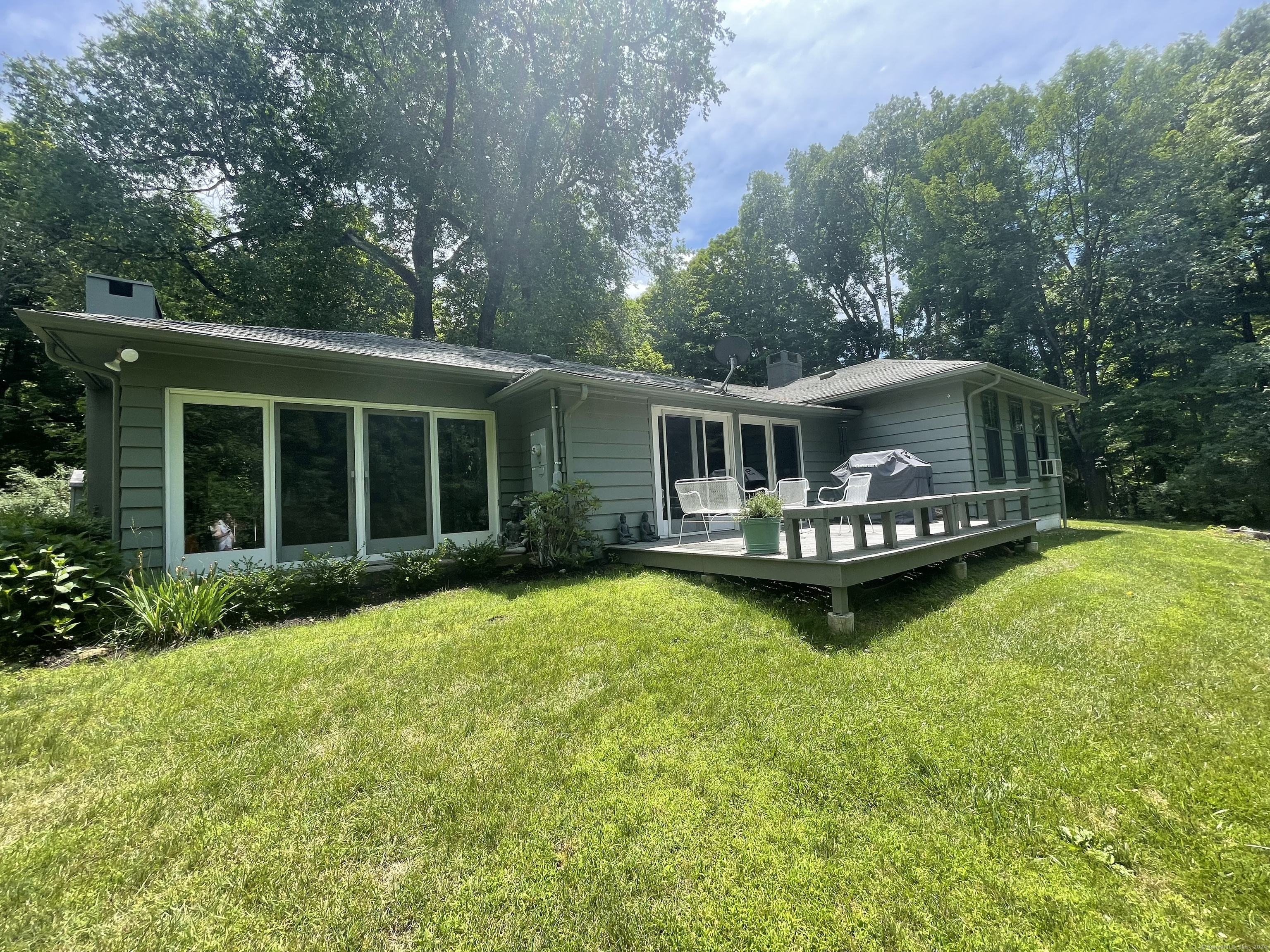 a view of house with backyard space and balcony