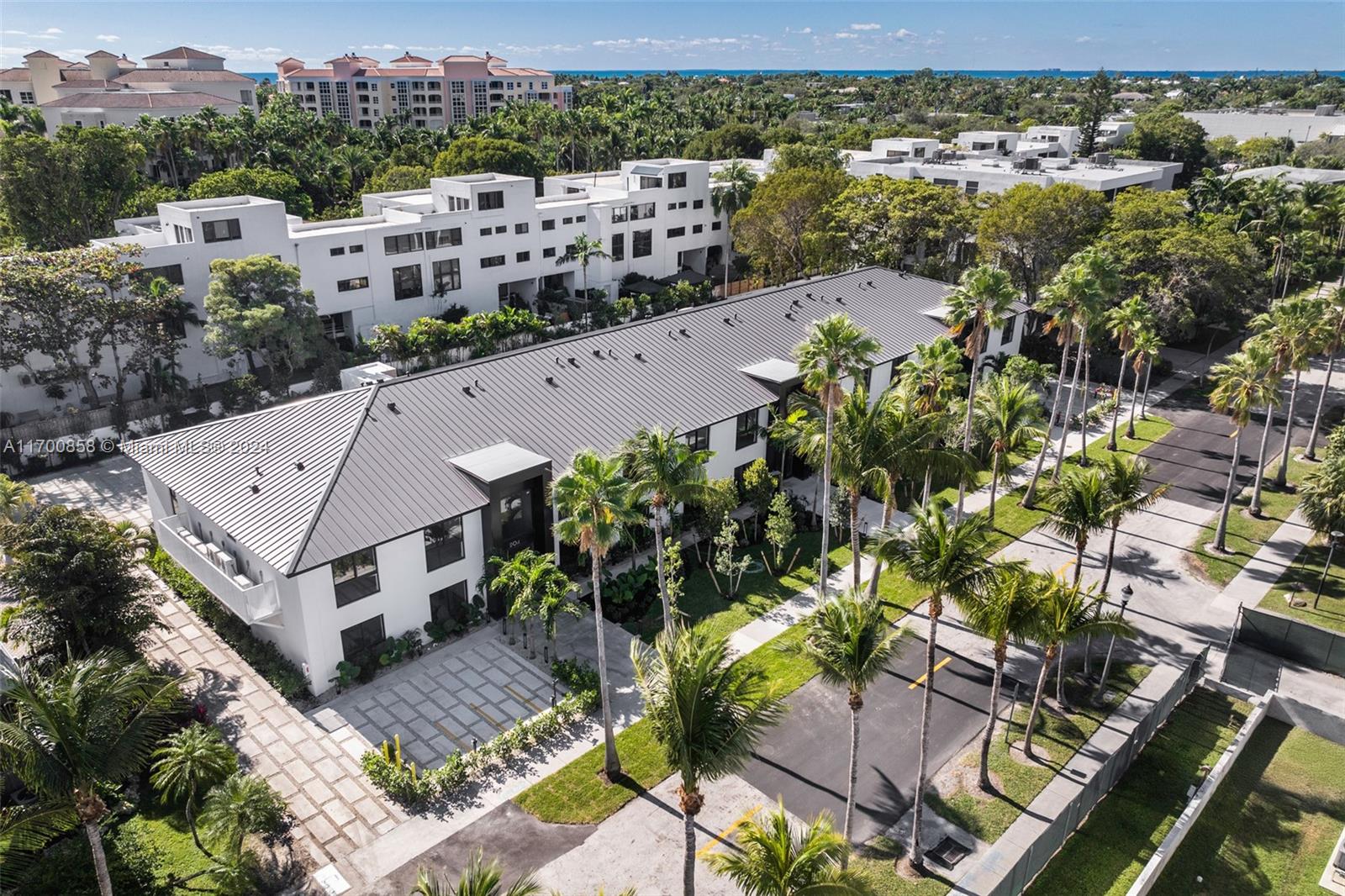 an aerial view of multiple houses with a yard