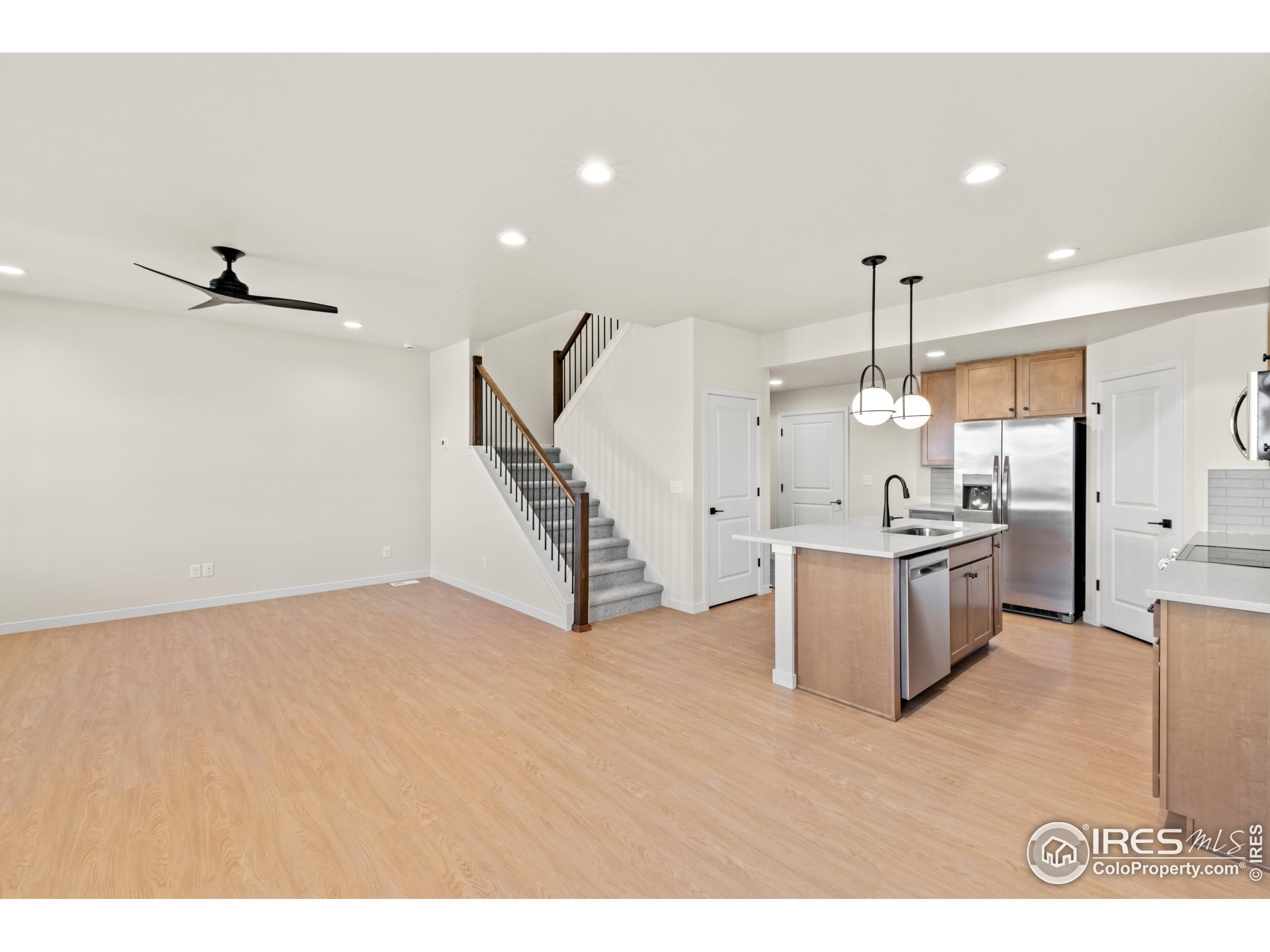 a view of a kitchen with a sink and a refrigerator