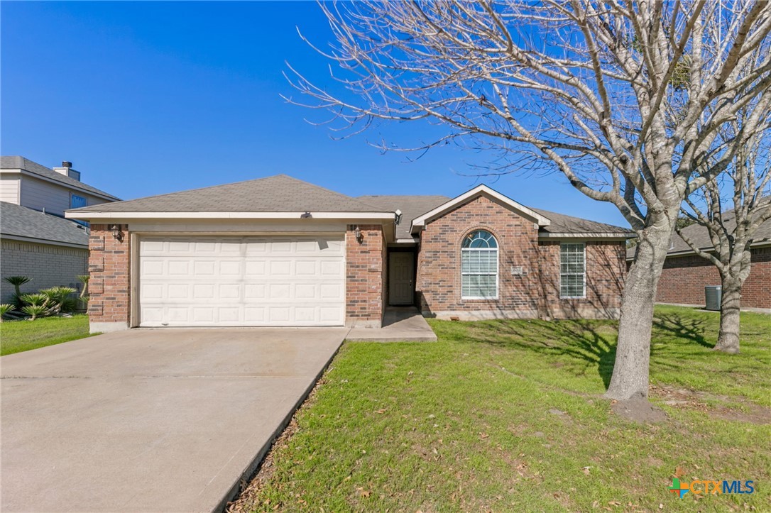 a view of a house with a yard and garage