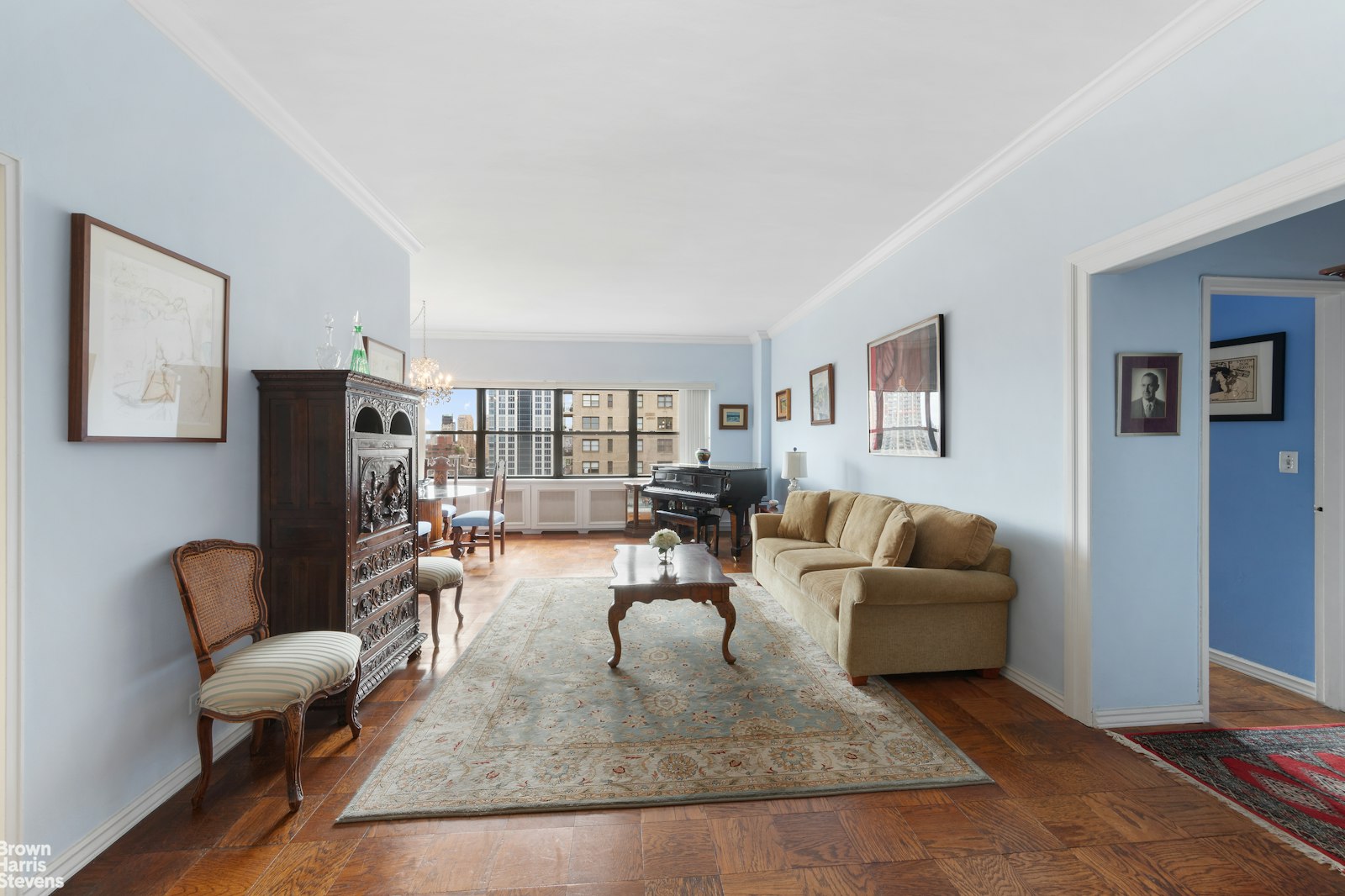 a living room with fireplace furniture and a rug