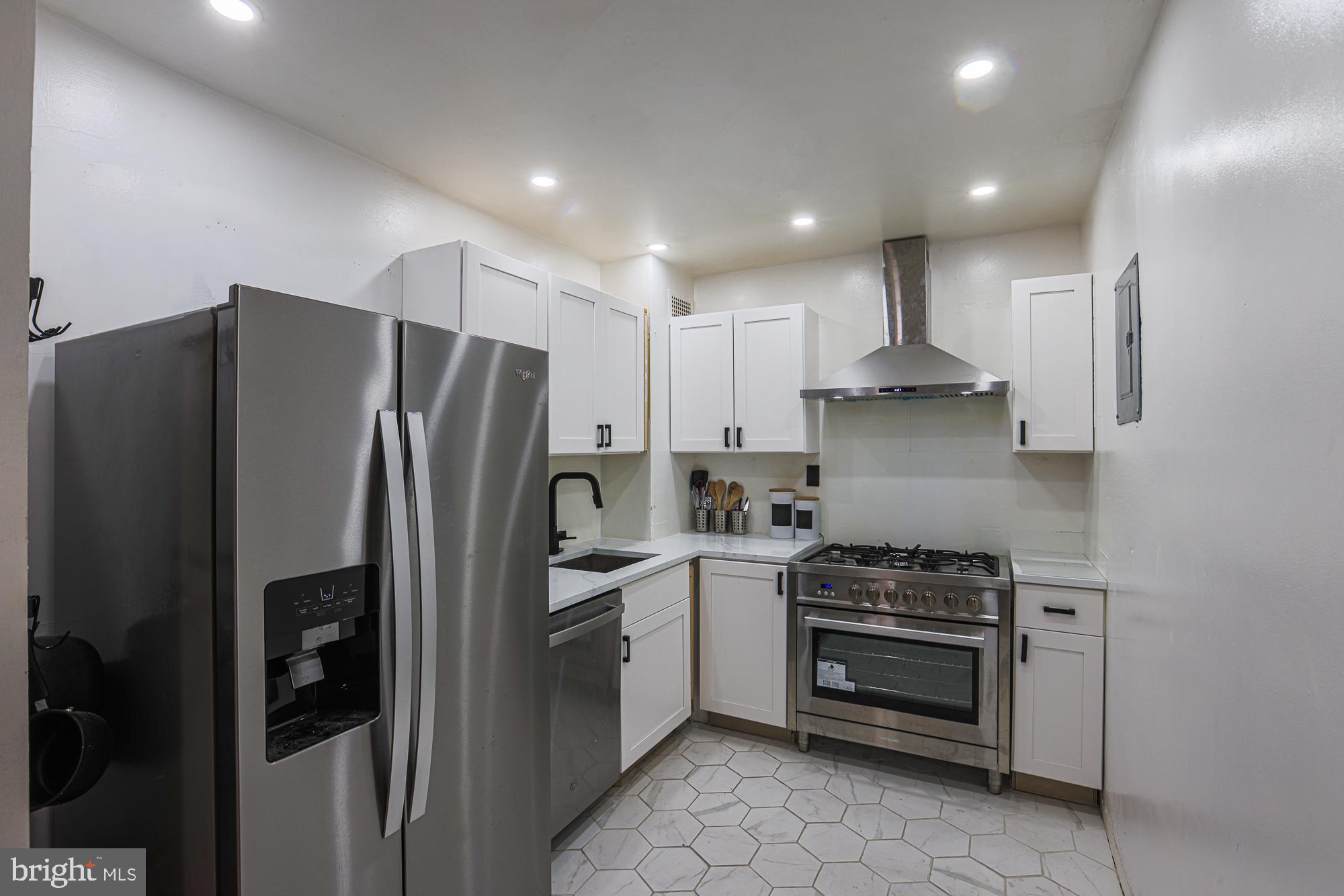 a kitchen with stainless steel appliances a refrigerator stove and microwave