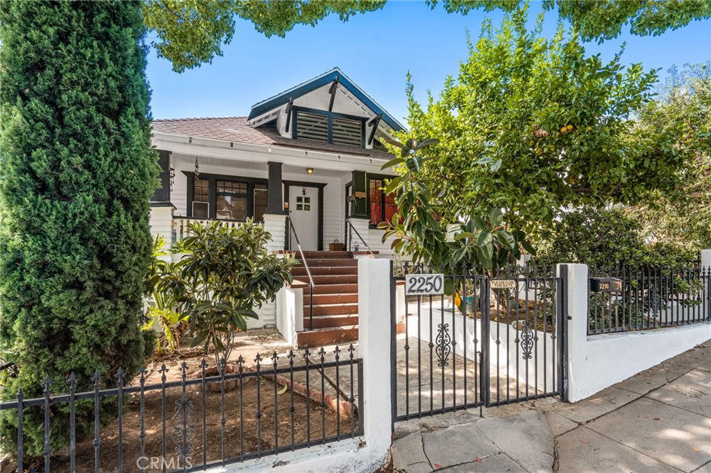 a front view of a house with trees