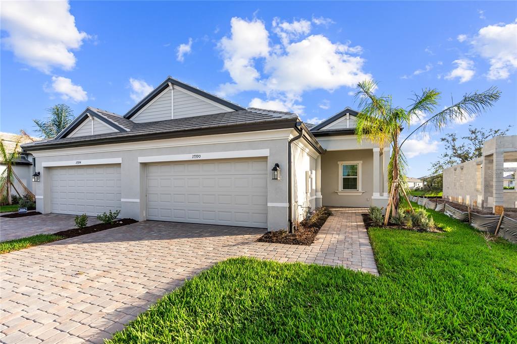 a front view of a house with a yard and garage