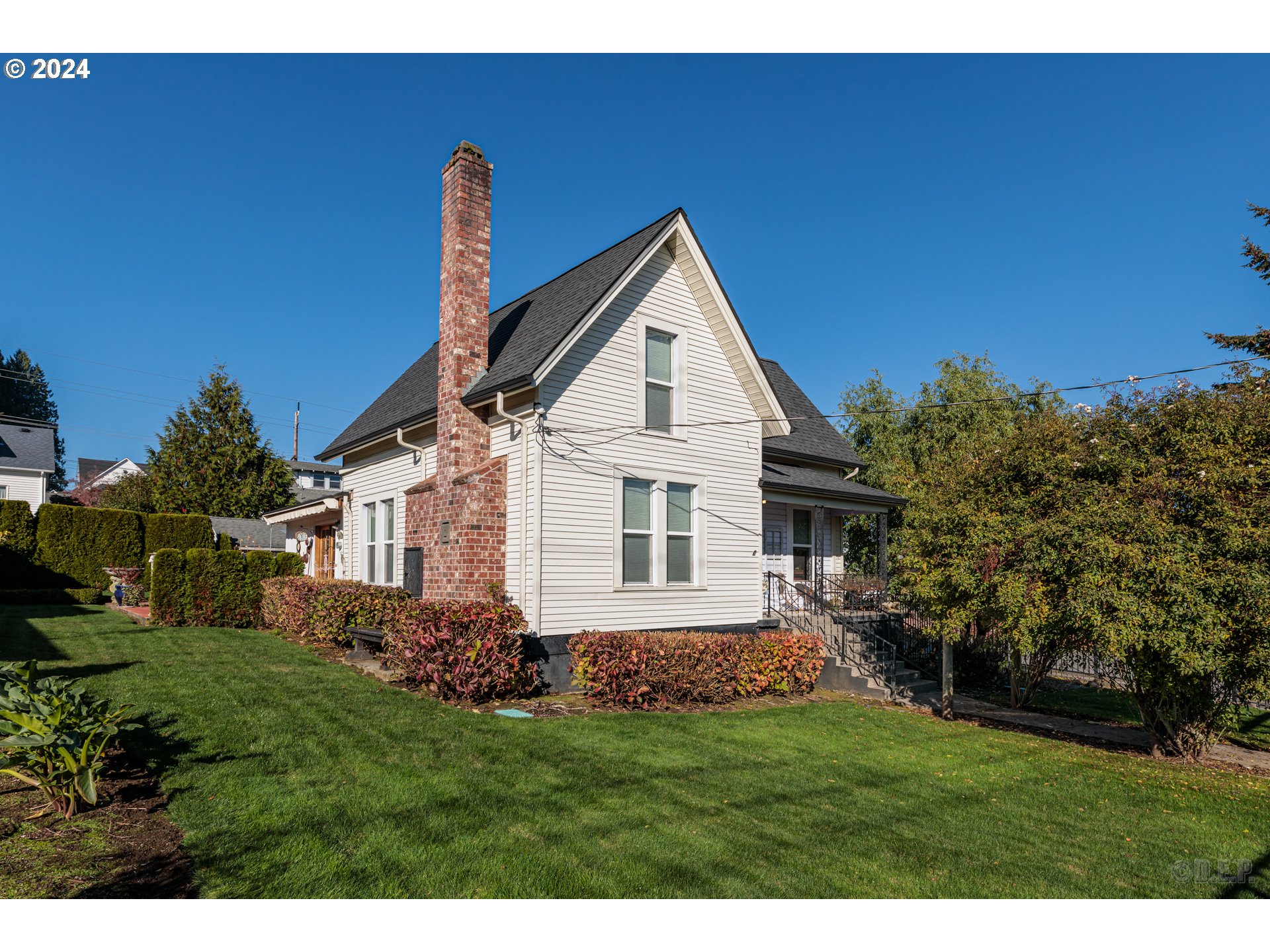 a front view of house with a garden