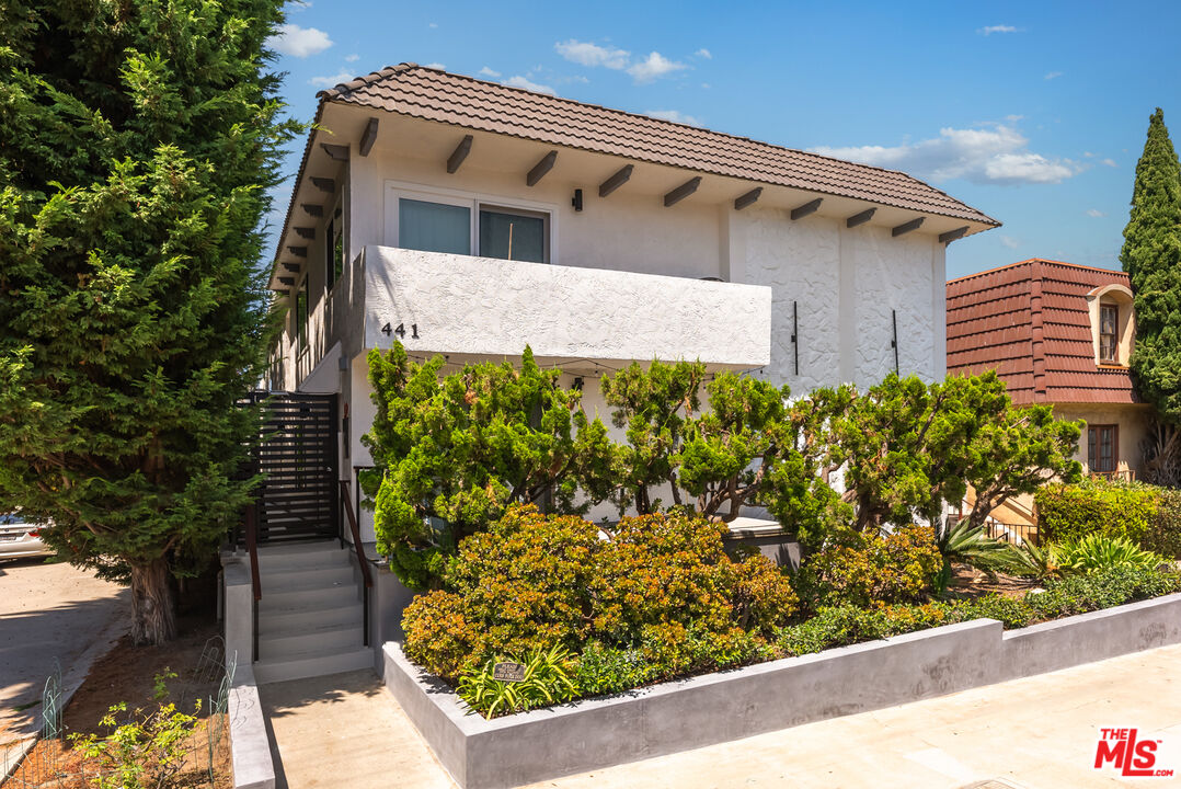 a front view of a house with a yard and covered outdoor seating