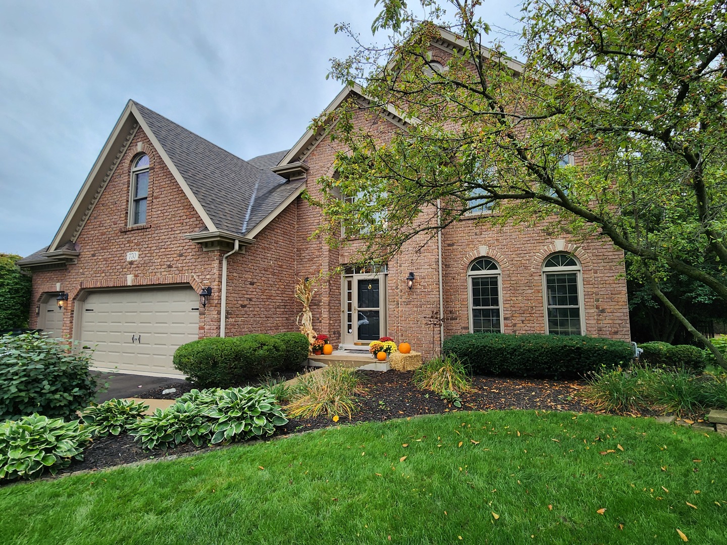 a front view of a house with a yard and garage