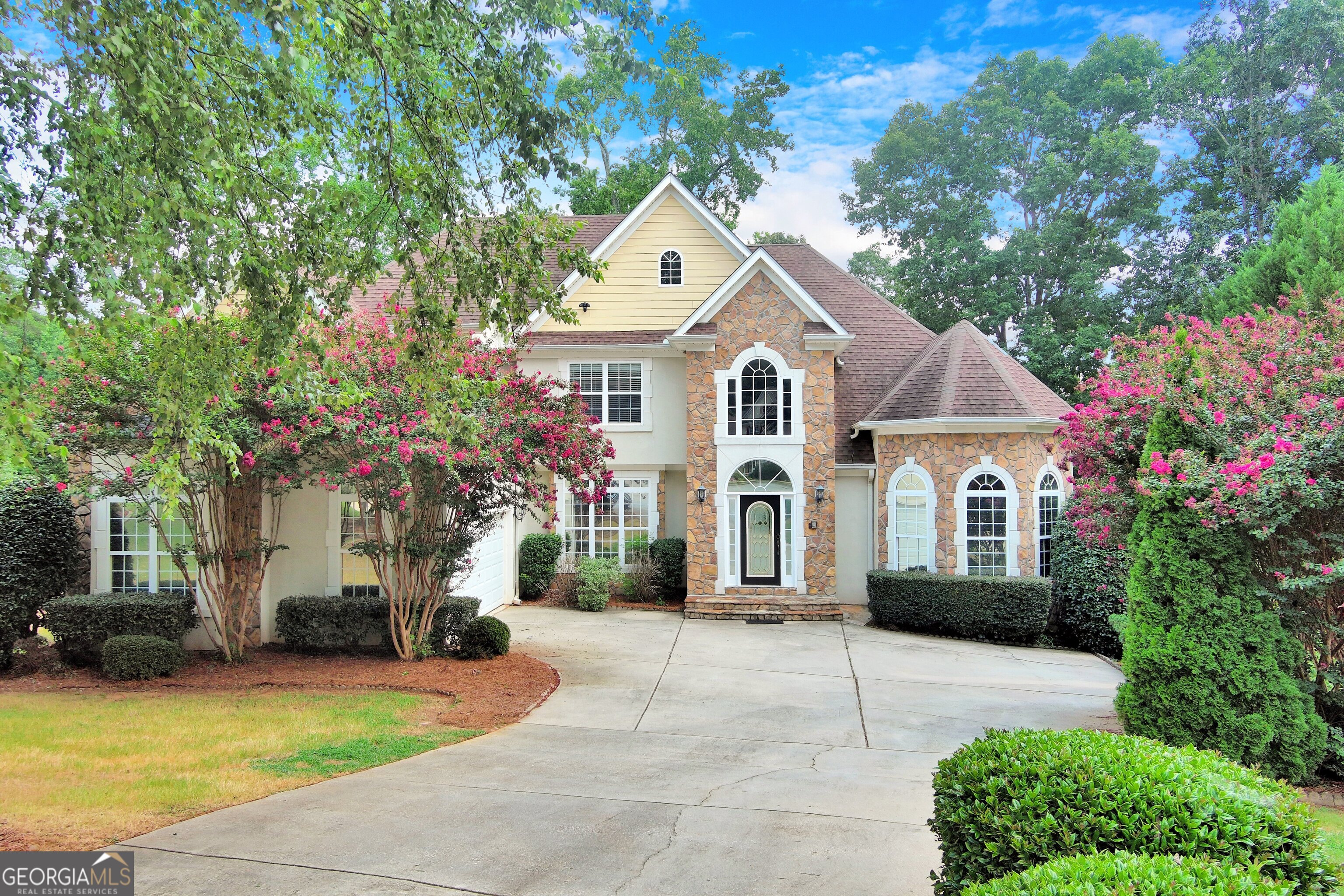 a front view of a house with a yard and garage