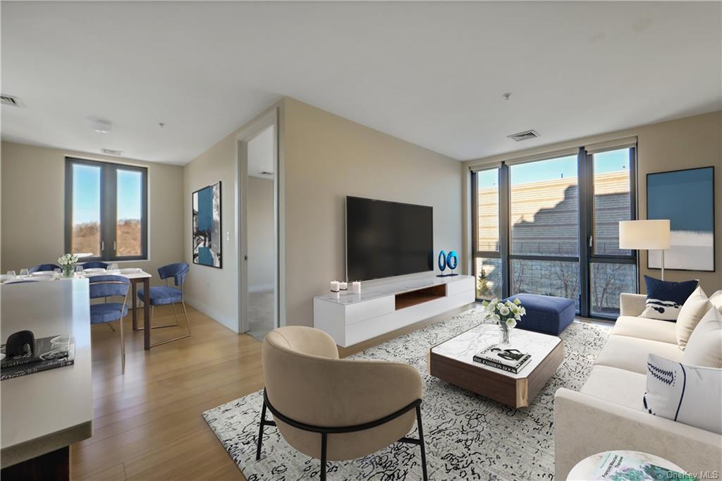 Living room featuring light hardwood / wood-style floors and plenty of natural light