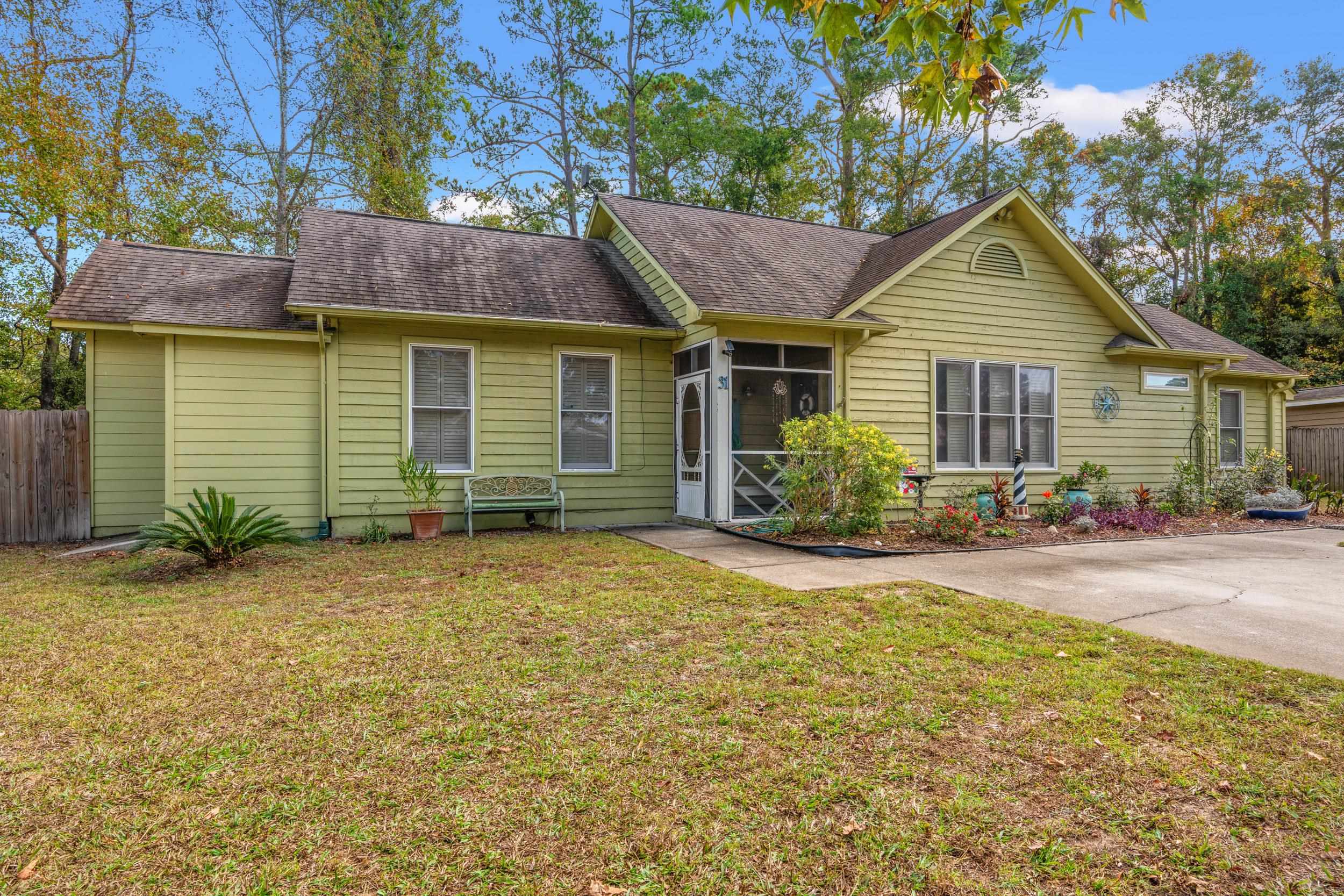 Ranch-style home with a front lawn and a sunroom