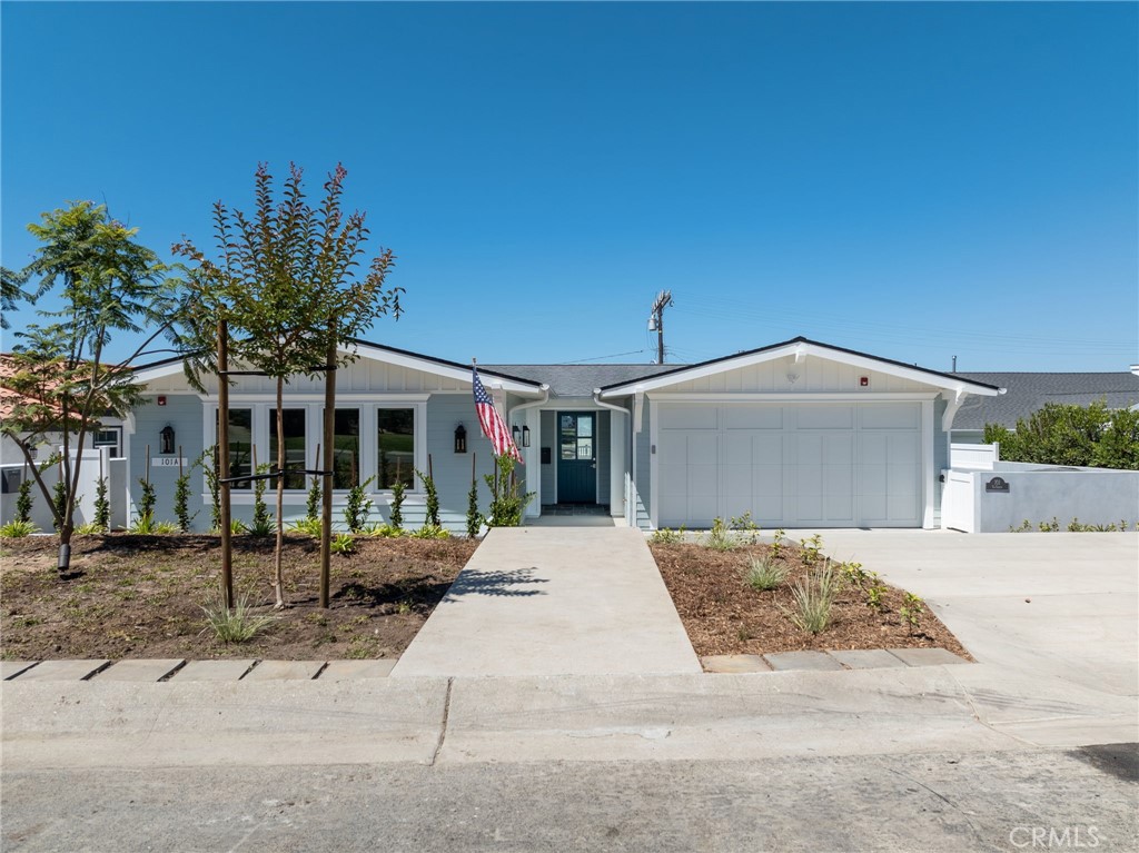 a view of a house with a yard and garage