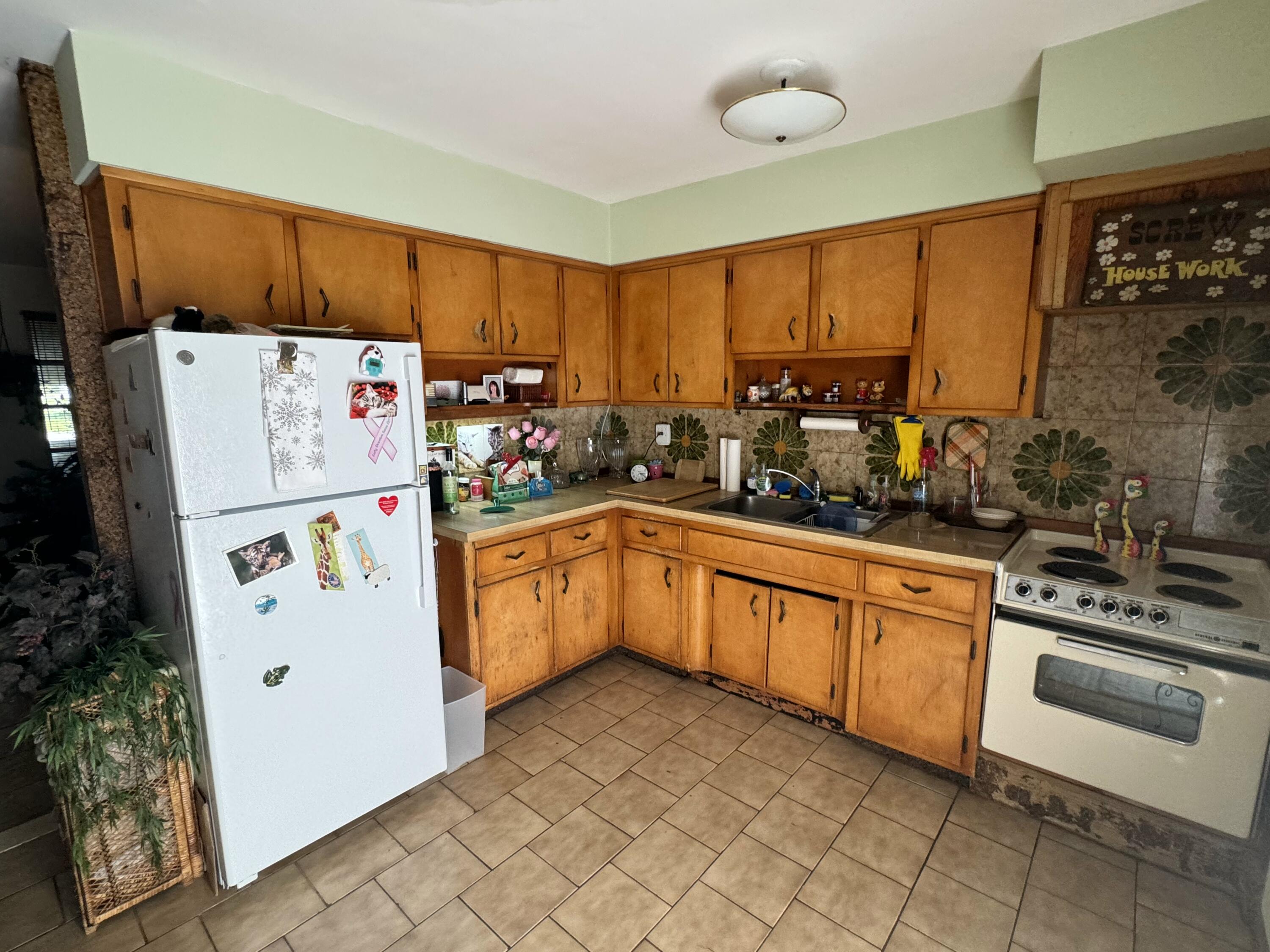 a kitchen with a refrigerator and a sink