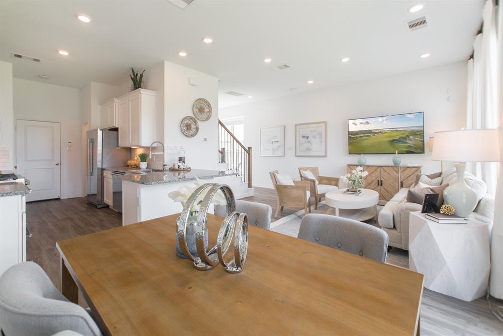 a living room with furniture kitchen and a large window