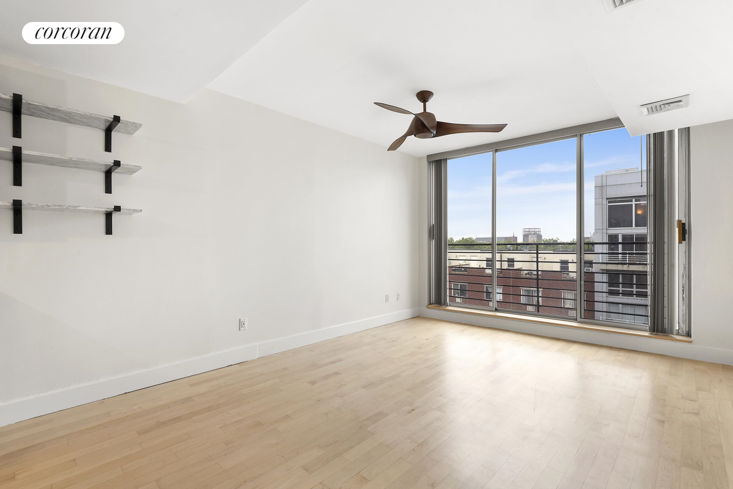 wooden floor in an empty room with a window