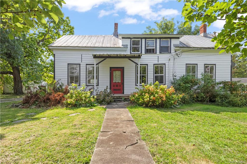 a front view of a house with a garden