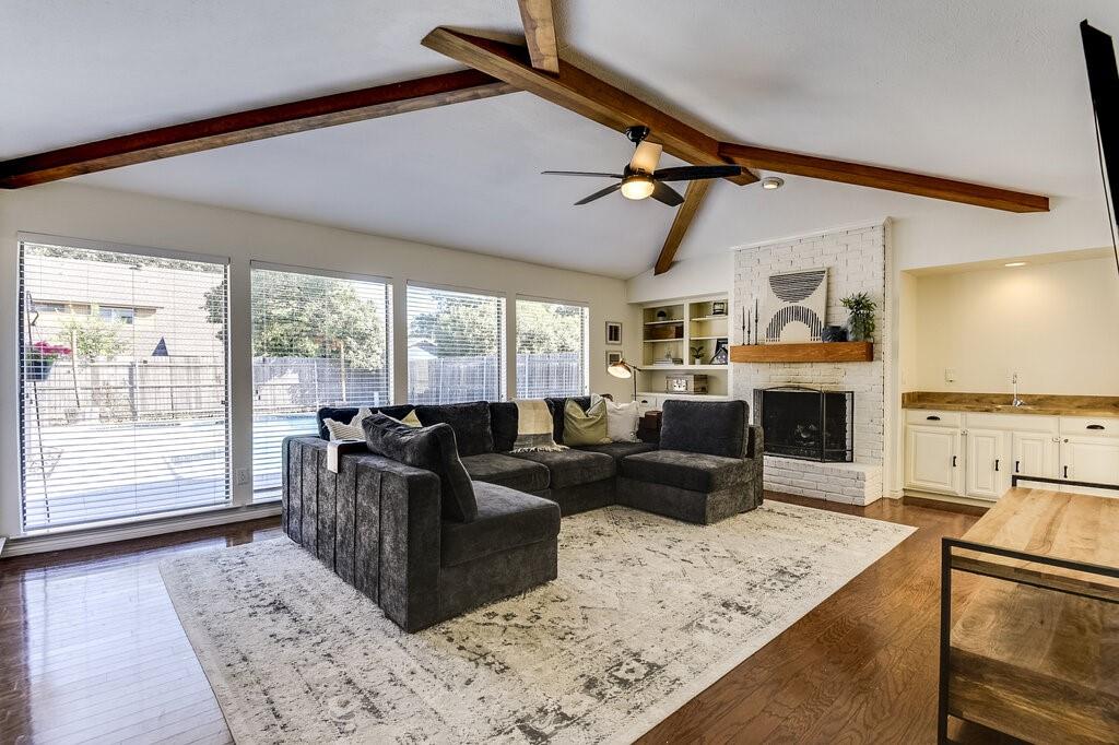 a living room with furniture large window and flat screen tv