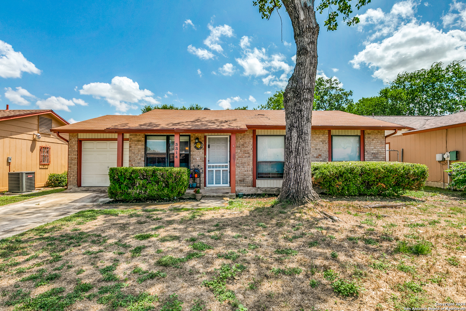 a view of a house with a tree in the yard