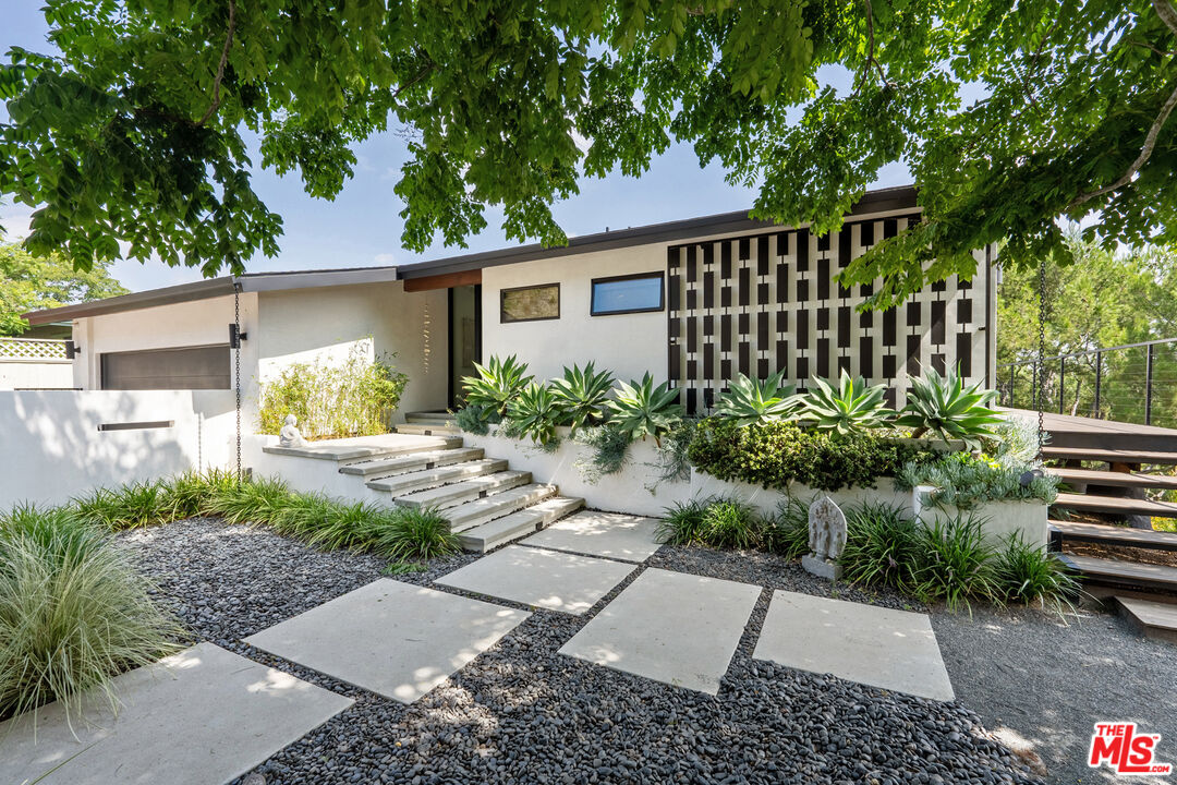 a front view of a house with garden