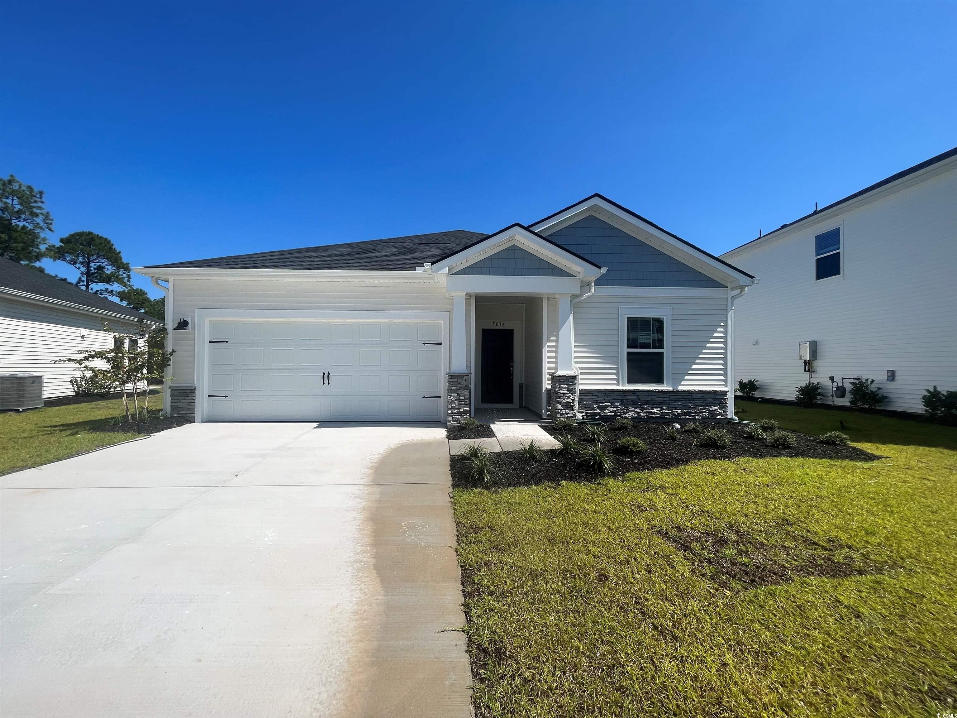 View of front of home featuring a garage, central