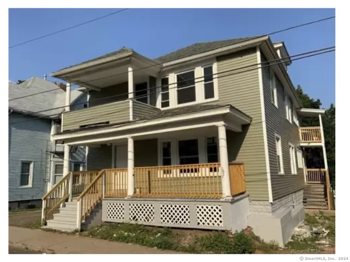 a view of a house with a door and balcony