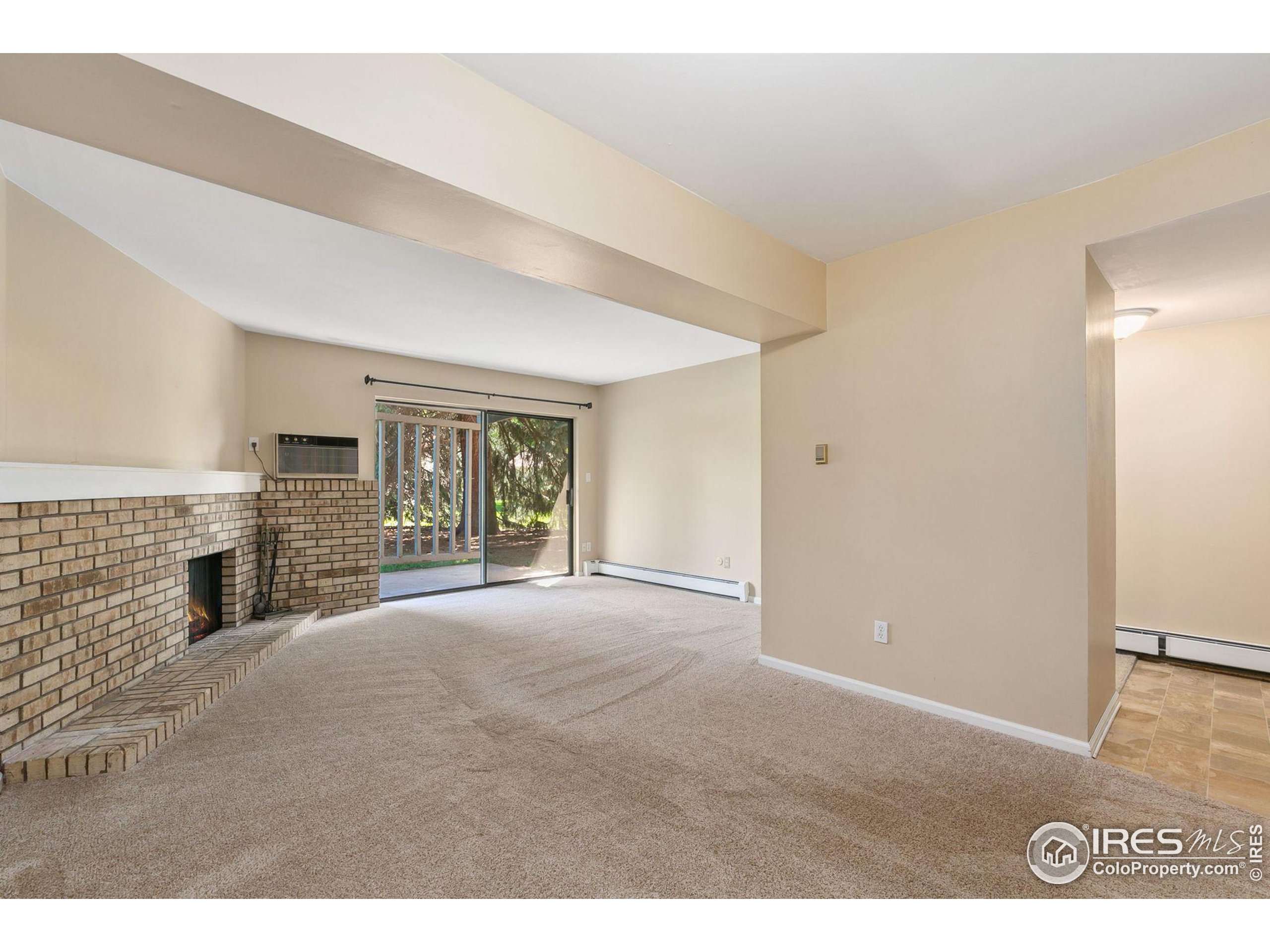 a view of empty room with fireplace