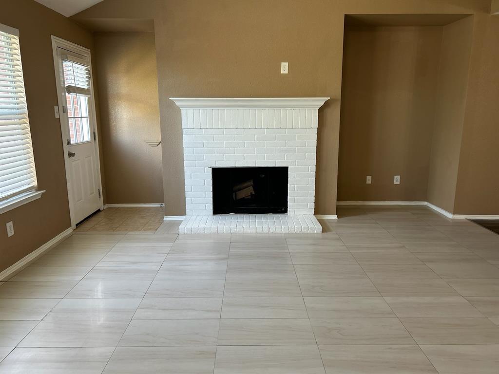 a view of an empty room with a fireplace