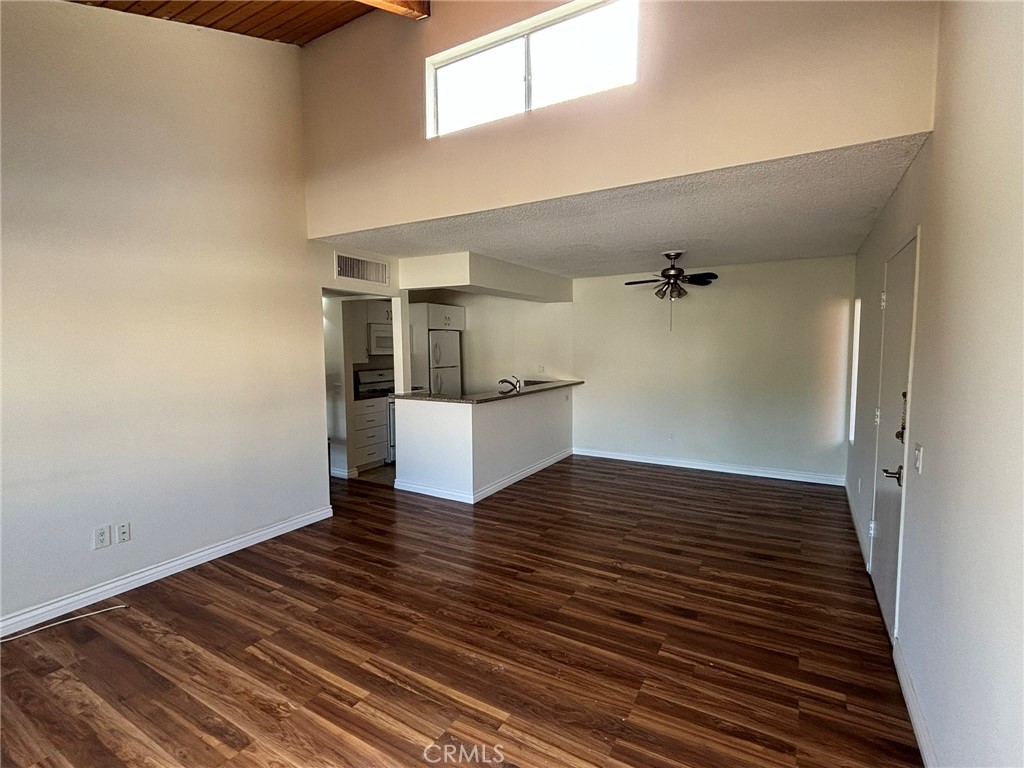 a view of a room with wooden floor and staircase