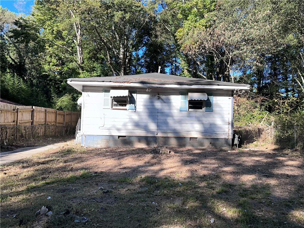 a view of house with backyard