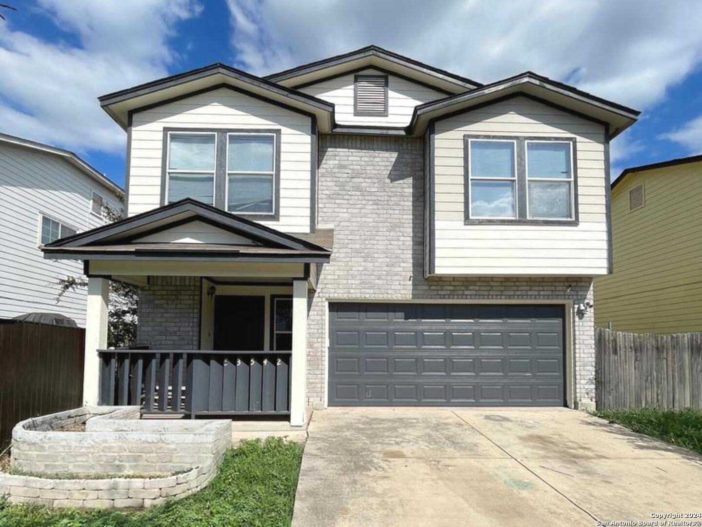 a front view of a house with a yard and garage