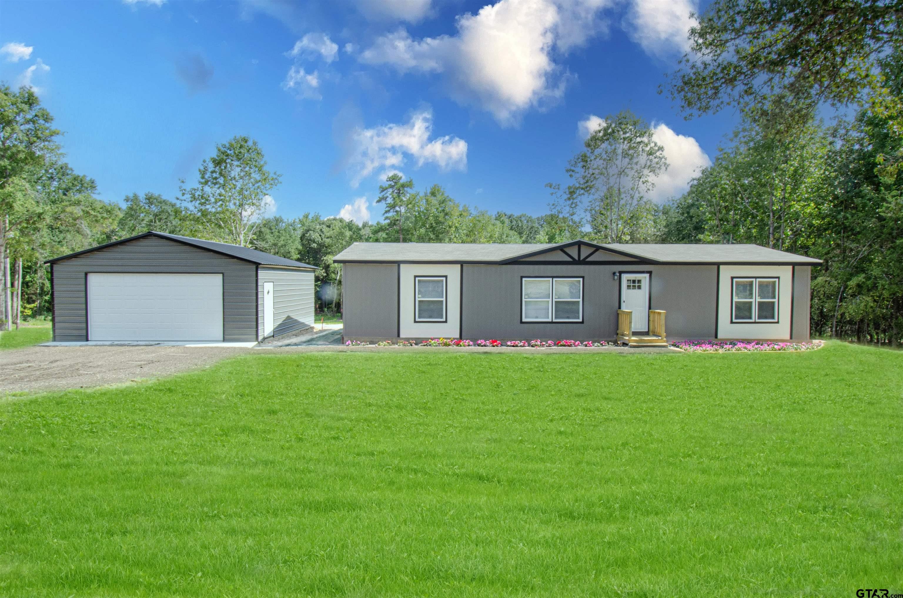 a view of a house with a back yard