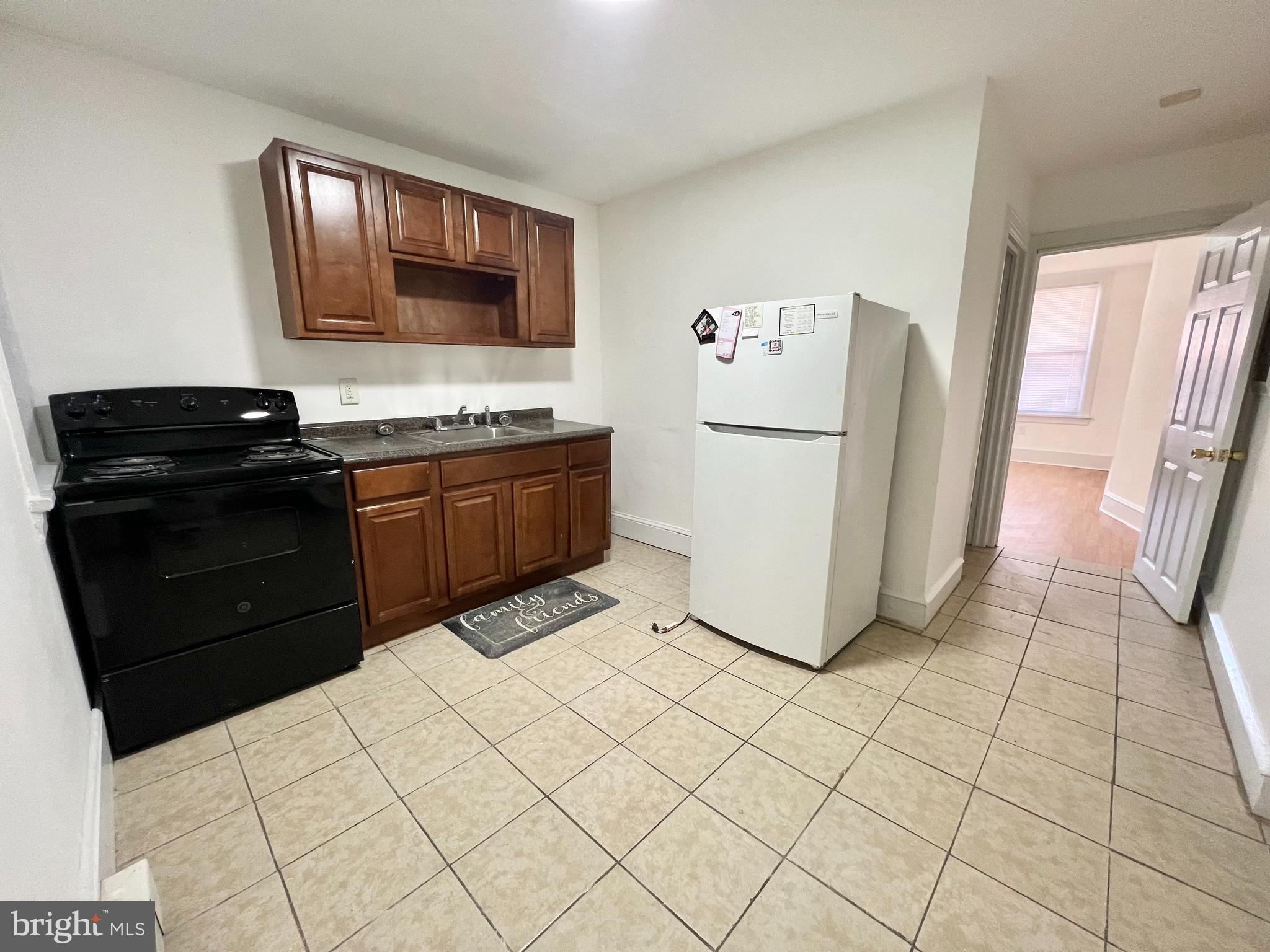 a kitchen with stainless steel appliances a refrigerator sink and stove