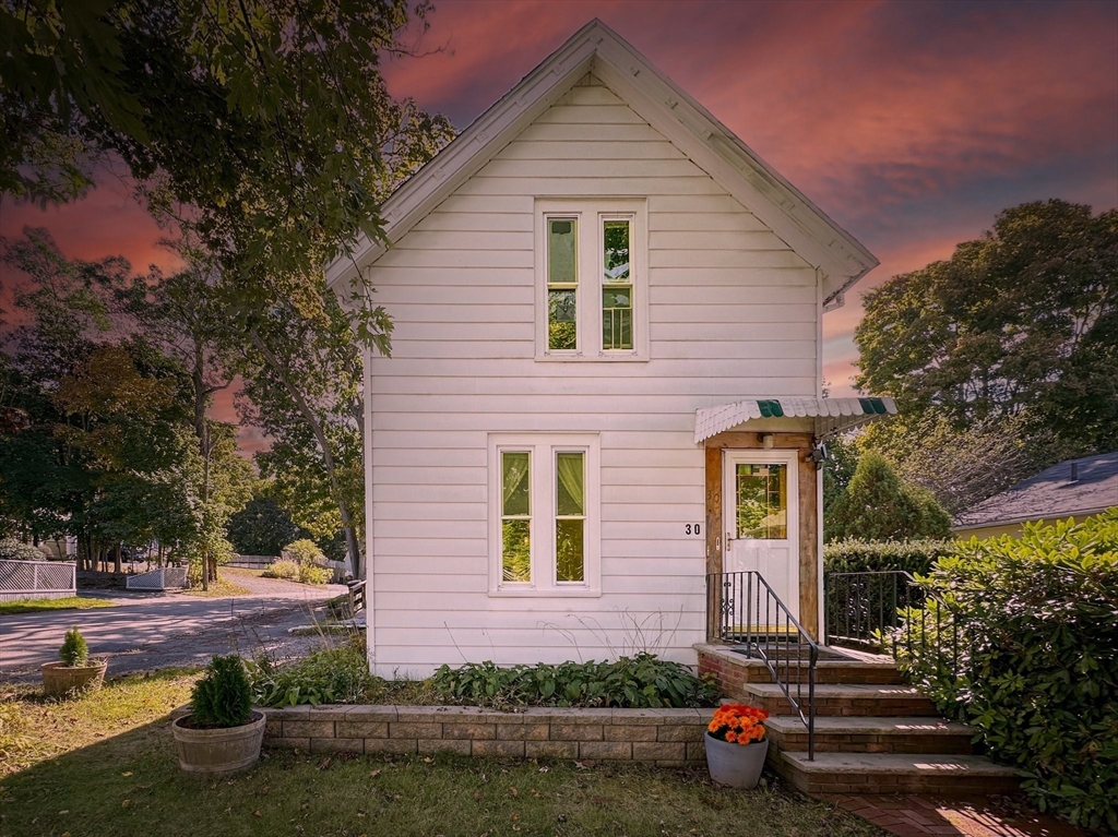 a front view of a house with garden