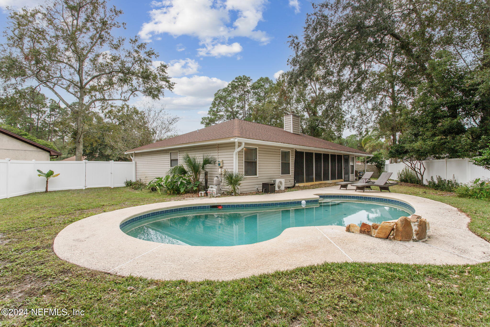 a front view of house with yard swimming pool and seating space