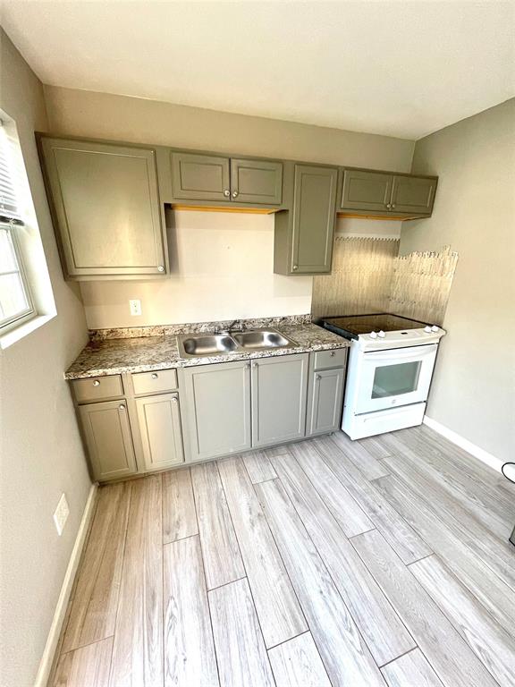 a kitchen with stainless steel appliances granite countertop a sink and a stove