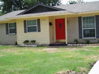 a view of a house with yard and sitting area