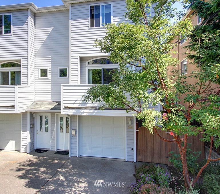 a front view of a house with a yard and tree s